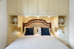 a bedroom with a large bed with blue pillows at Le Terrazze Di Serafina in Furore