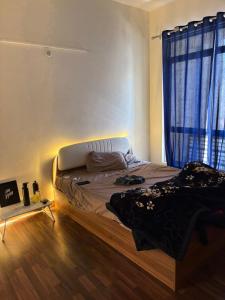 a bedroom with a bed in a room with a window at Express view homes in Noida
