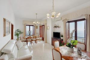a living room with a white couch and a table at Le Terrazze Di Serafina in Furore