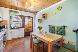 a kitchen with a wooden table in a room at Gästehaus Absbachtal in Bad Rippoldsau-Schapbach