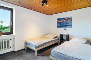 a bedroom with two beds and a window at Fribo in Ostrach