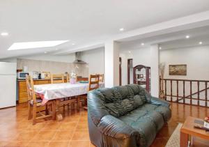 a living room with a couch and a table at Villa com 4 apartamentos in Apúlia