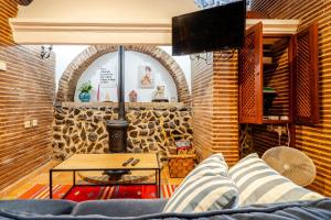 a living room with a couch and a table at Casa Do Castelo in Beja