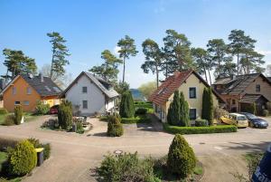 a group of houses with cars parked in a driveway at Fewo 20 Röbel Müritzblickhaus in Röbel
