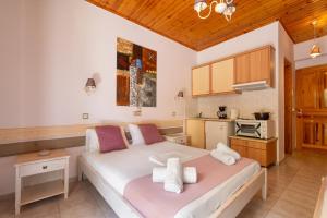 a bedroom with a large bed and a kitchen at Nontas Homes 37 in Kalamitsi +20 photos