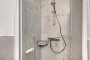 a shower with a shower head in a bathroom at Tra-monti e Mare Bormio in Valdidentro +20 photos