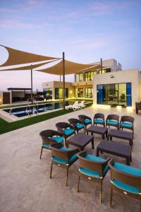 a group of chairs sitting in front of a house at Devon Chalet in Amman
