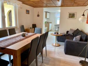 a dining room and living room with a wooden table at Fischerhaus Zecherin in Zecherin