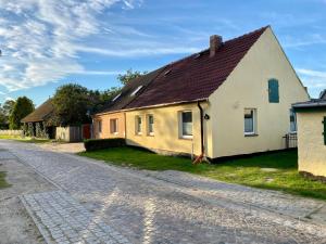 a yellow house on the side of a road at Fischerhaus Zecherin in Zecherin