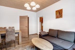a living room with a couch and a table at Fewo In Schustes in Willingen +13 photos