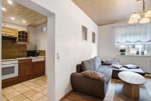 a living room with a couch and a table at Fewo In Schustes in Willingen