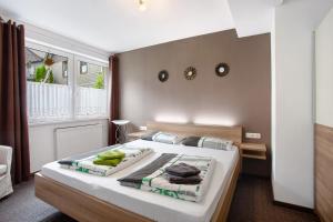 a bedroom with a large bed with towels on it at Fewo In Schustes in Willingen