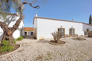 a white building with a tree in front of it at Daniel Cottage - Portimão in Portimão