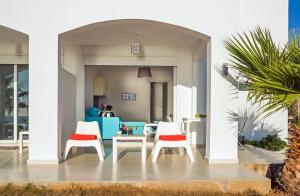 a living room with two chairs and a table at Kaladi Rock Avlemonas in Avlemonas