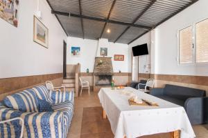 a living room with a table and chairs and a fireplace at Finca El Abuelo in Lepe