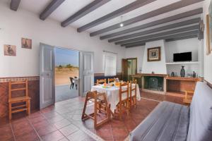 a dining room with a table and chairs at Finca El Abuelo in Lepe