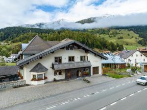 a house on the side of a road with mountains at Appartement Egart 1 in Resia