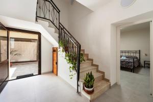 a staircase in a house with potted plants at Villa Giovia in Guspini