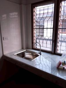 a kitchen counter with a sink and a window at บ้านกรรณิการ์ in Chiang Mai +13 photos