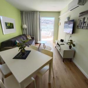 a living room with a table and a couch at Apartamento Joya in Puerto Rico de Gran Canaria
