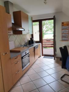 a kitchen with a sink and a stove at Ferienwohnung in Etelsen in Langwedel