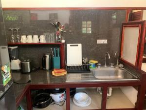 a kitchen counter top with a sink and a counter top at Villa 3 - High End Studio Apartment with kitchen, Playa Chiquita in Cocles
