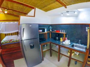 a kitchen with a stainless steel refrigerator and a sink at Villa 3 - High End Studio Apartment with kitchen, Playa Chiquita in Cocles