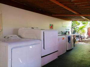 a laundry room with white washers and dryers at Villa 3 - High End Studio Apartment with kitchen, Playa Chiquita in Cocles