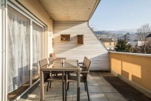 a wooden table and chairs on a balcony at Kilian in Schwarzach