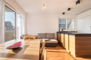 a kitchen and living room with a table and a couch at Kilian in Schwarzach