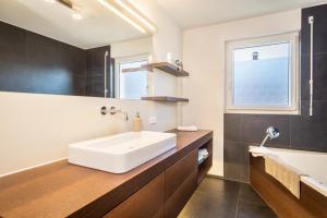 a bathroom with a large white sink and a window at Kilian in Schwarzach +15 photos