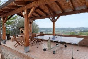 a ping pong table in a pavilion on a patio at Tenuta Paradiso in Portacomaro