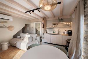 a bedroom with a white bed and a kitchen at Cozy Sommavilla Residence in Brenzone sul Garda +54 photos