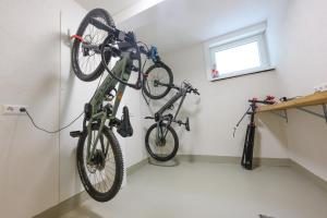 two bikes hanging on a wall in a room at Ferienwohnung Bergblick in Kappelrodeck