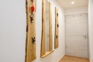 a hallway with a mirror and a door at Ferienwohnung Bergblick in Kappelrodeck