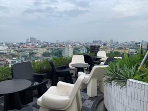 a group of tables and chairs sitting on a roof at Thien Thai Hotel & Spa in Hanoi +36 photos