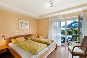 a bedroom with a bed and a balcony at Ferienhaus Lydia in Sasbach in der Ortenau