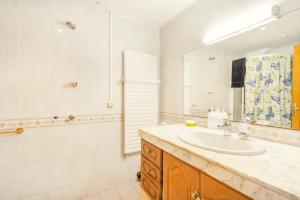 a bathroom with a sink and a shower and a mirror at Cal Confianza in Borredá +13 photos