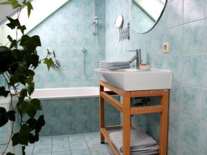 a bathroom with a sink and a bath tub at Ferienwohnung auf der Baar in Bad Dürrheim +26 photos