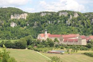 a large building in front of a mountain at Ferienwohnung auf der Baar in Bad Dürrheim