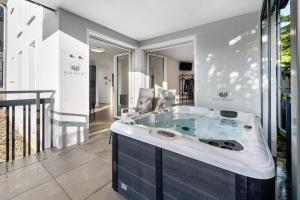 a bathroom with a tub in the middle at Egge Resort 7a mit Whirpool u Sauna in Altenbeken +17 photos