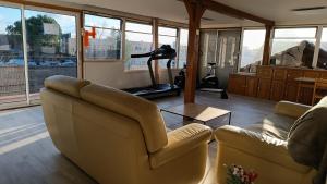a living room with two couches and a gym at Chez Léa in Bourges