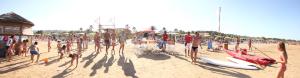 a group of people standing on a beach with surfboards at Oasi Beach Hotel in Vieste