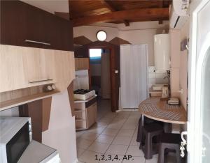 a small kitchen with a table in a room at CSABA-EMILKA-SPA Apartmanok in Hajdúszoboszló +51 photos
