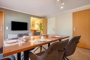 a dining room with a wooden table and chairs at Ferienwohnung Ankerplatz in Osterbruch