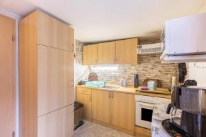 a kitchen with wooden cabinets and a white refrigerator at Ferienhäuschen Wils in Borkheide