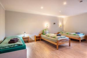 a room with two beds and two tables in it at Ferienwohnung Ankerplatz in Osterbruch