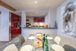 a kitchen and dining room with a table and chairs at Coeur de neige 1724 in Le Grand-Bornand +14 photos