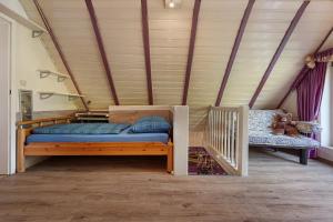 a bedroom with a bed and a crib in a room at Ferienhaus In Oerrel Mit Pool in Munster +19 photos