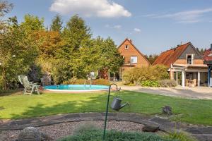 a yard with a swimming pool and a house at Ferienhaus In Oerrel Mit Pool in Munster